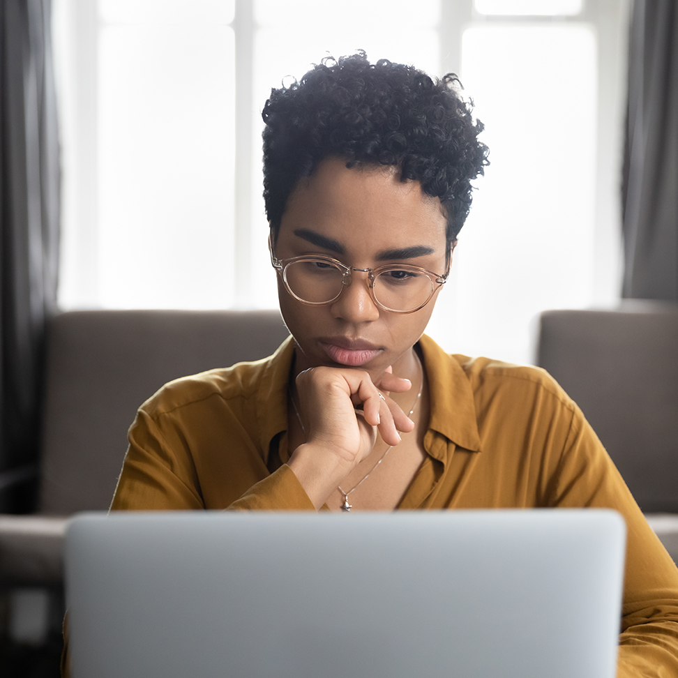 Woman using a laptop to work - Optometry Practice Growth in North America