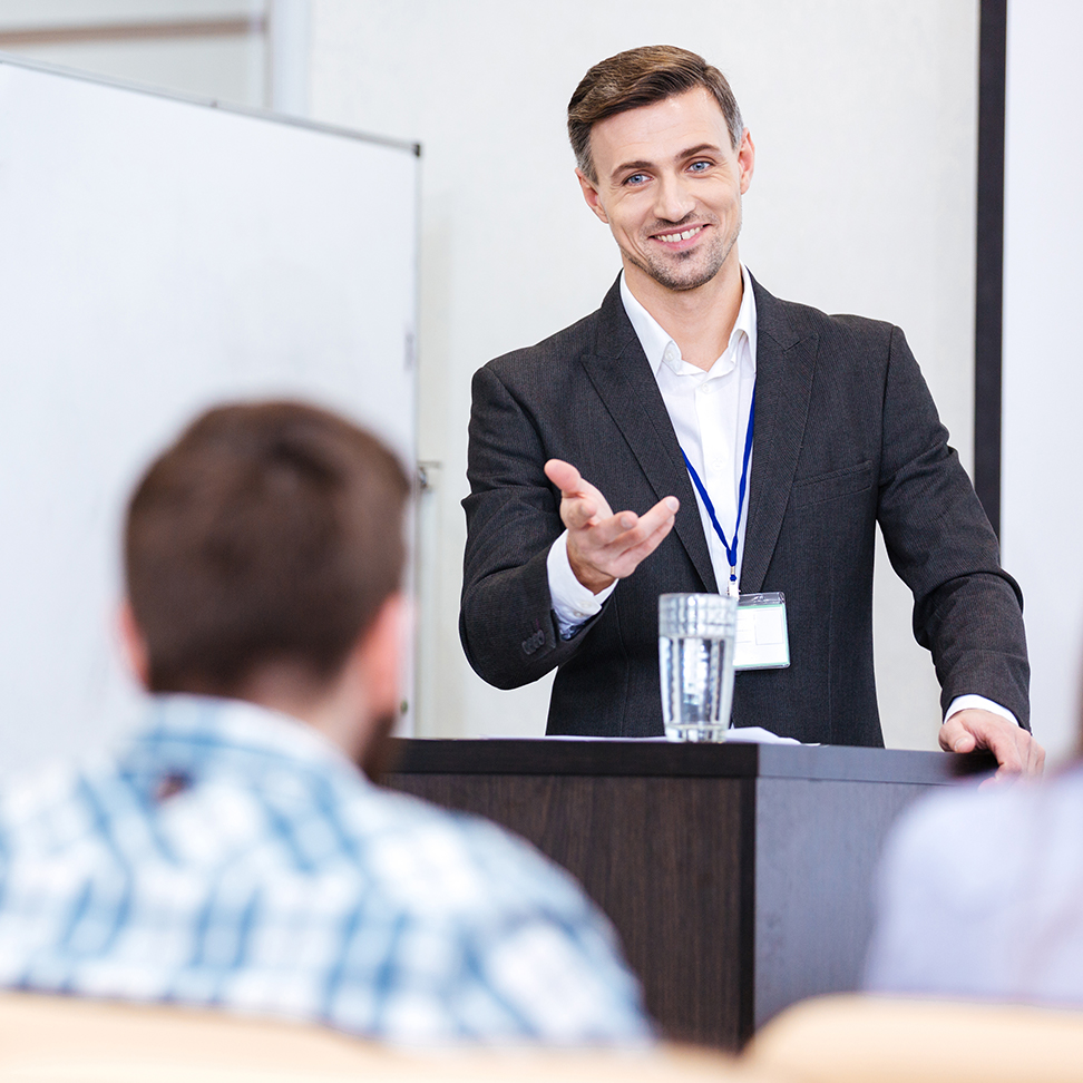 Man explaining to a crowd - Optometry Practice Growth in North America